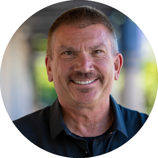 Headshot of a smiling male porcelain veneer patient.