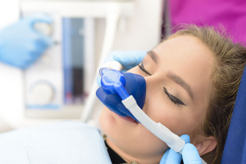 Atrtractive brunette female undergoing sedation dentistry with nitrous oxide.