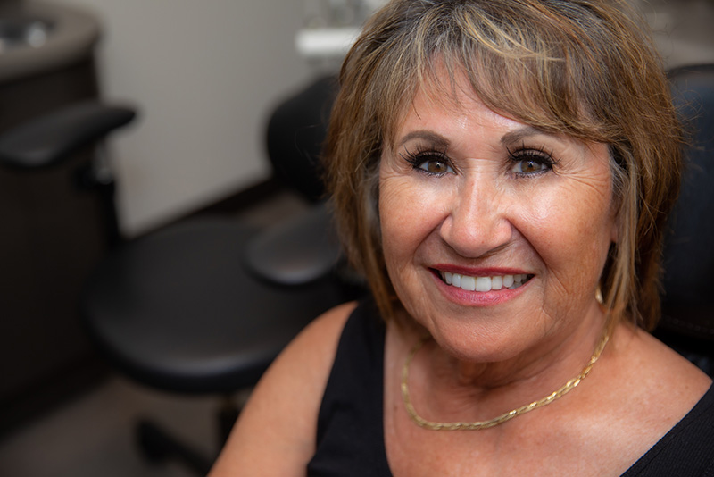 Wendy, a senior dental implant bridge recipient smiling.