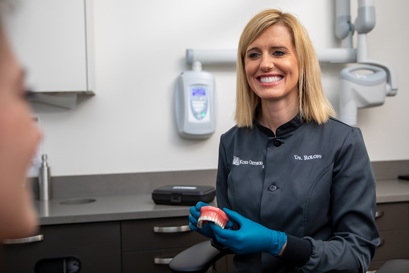 Orthodontist Dr. Brienne Roloff smiling at female invisalign recipient.