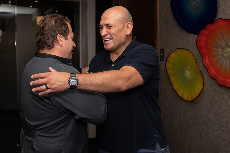 Prosthodontist Dr. Dean Kois greeting ex-UFC fighter, Ivan Salaverry with a man-hug.