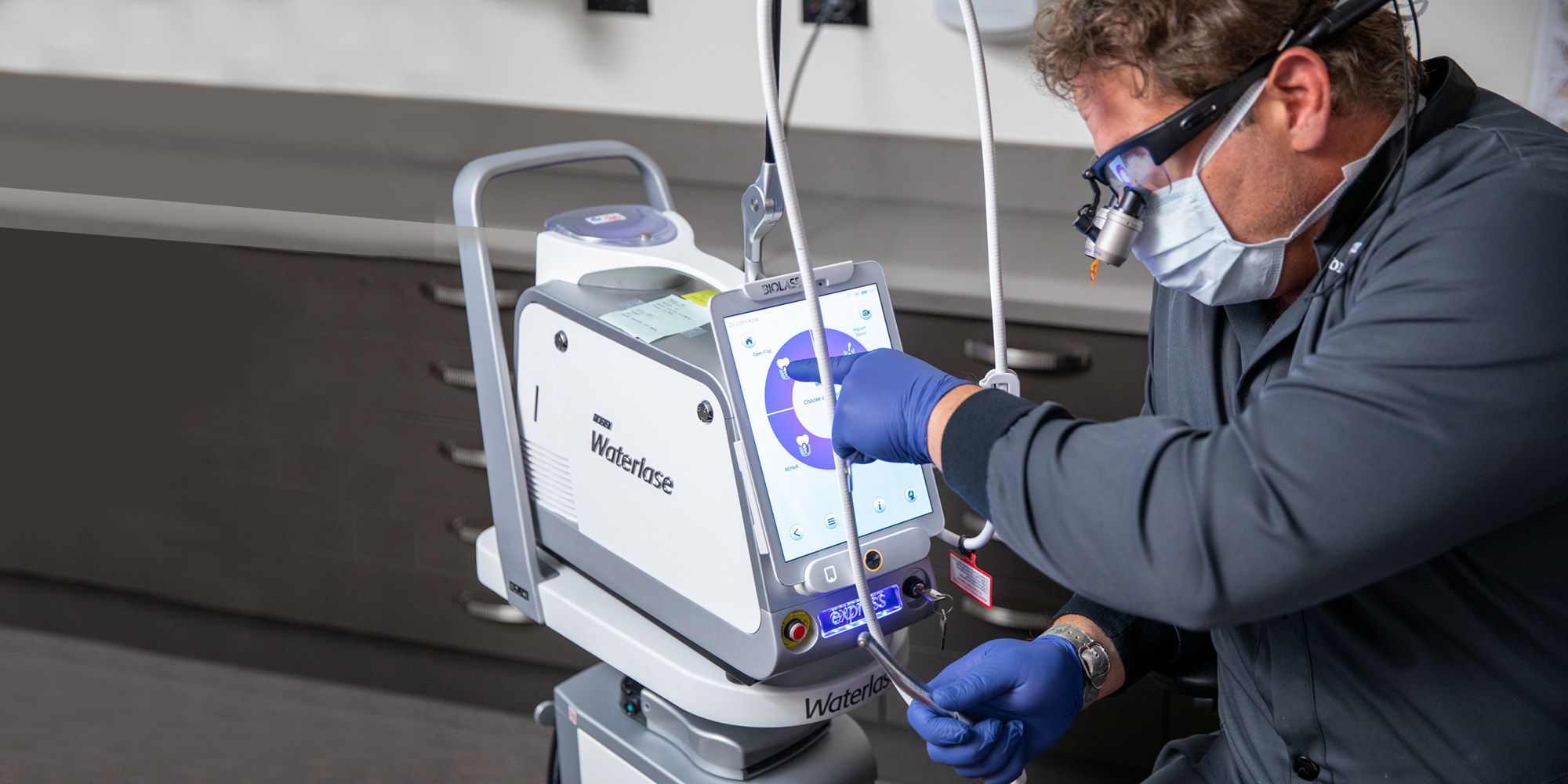 Prosthodontist Dr. Dean Kois configuring Biolase Waterlase for laser periodontal treatment.